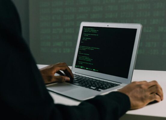 PERSON WORKING ON LAPTOP