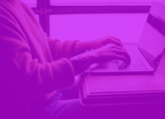 person on laptop with purple overlay