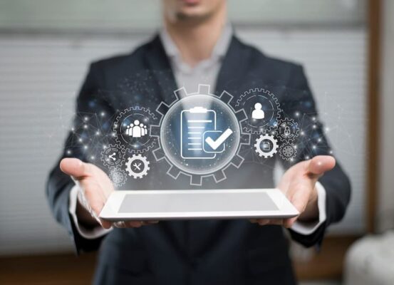 person holding ipad with business process graphic