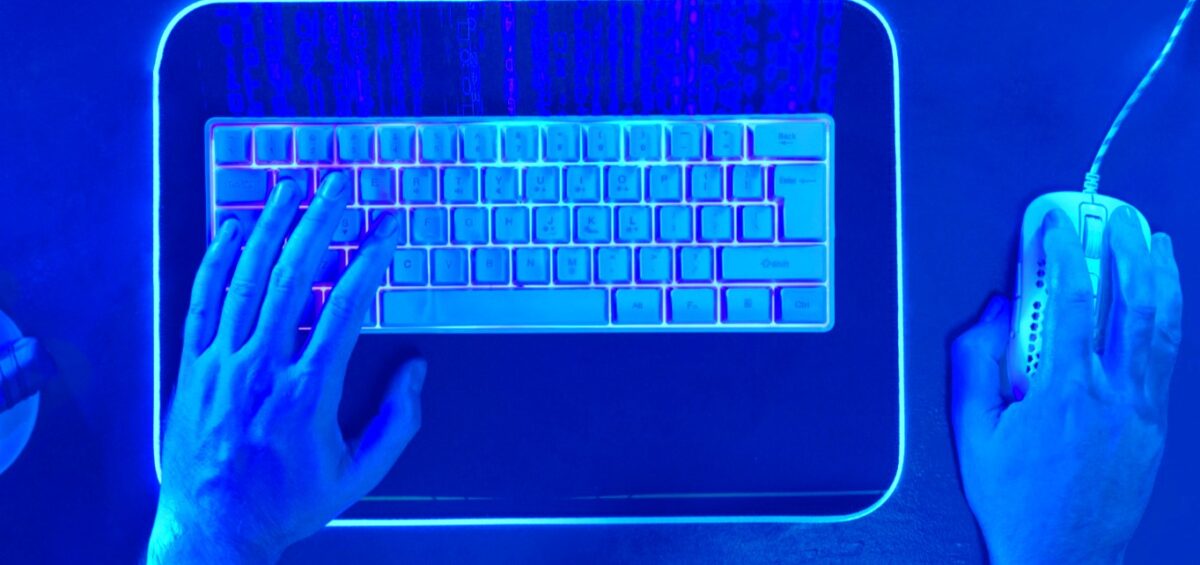 hands on a keyboard with blue overlay