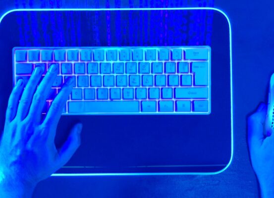 hands on a keyboard with blue overlay