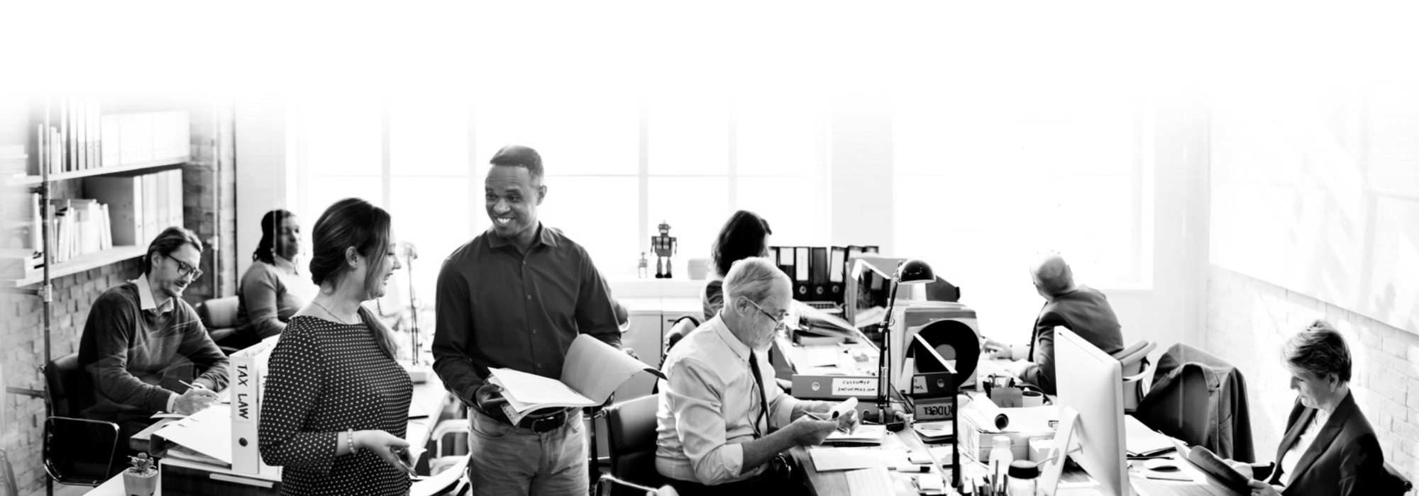 Coworkers conversing in black and white