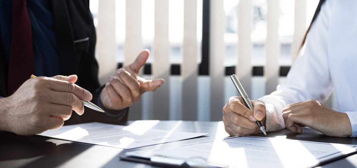 People signing important form