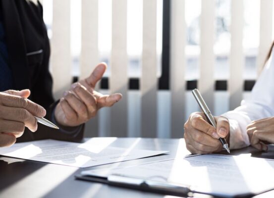 People signing important form